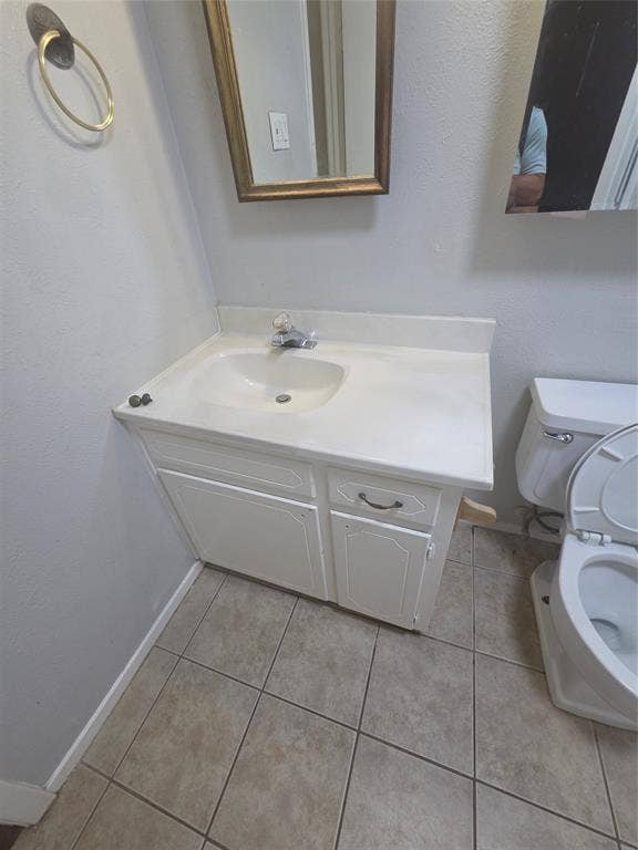 1717 N Locust Street, #6, Denton, TX 76201 Vanity with white cabinetry, integrated sink, and a framed mirror