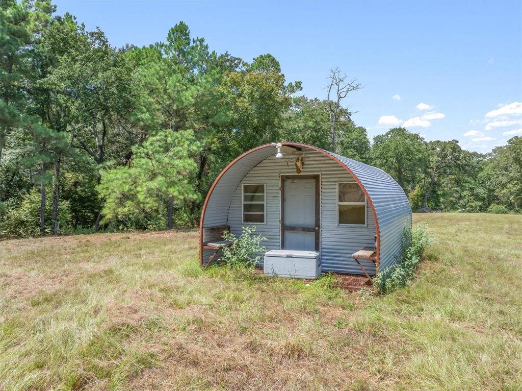 24670 Private Road 8102, Frankston, TX 75763 Corrugated metal structure with a single entry door and two windows