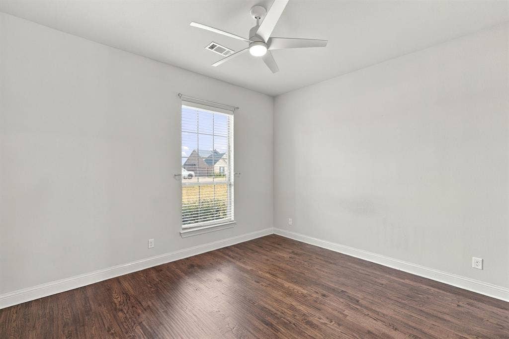 5620 Limestone Lane, Midlothian, TX 76065 Spacious guest bedroom offers Hardwood floors and looks over the front lawn.