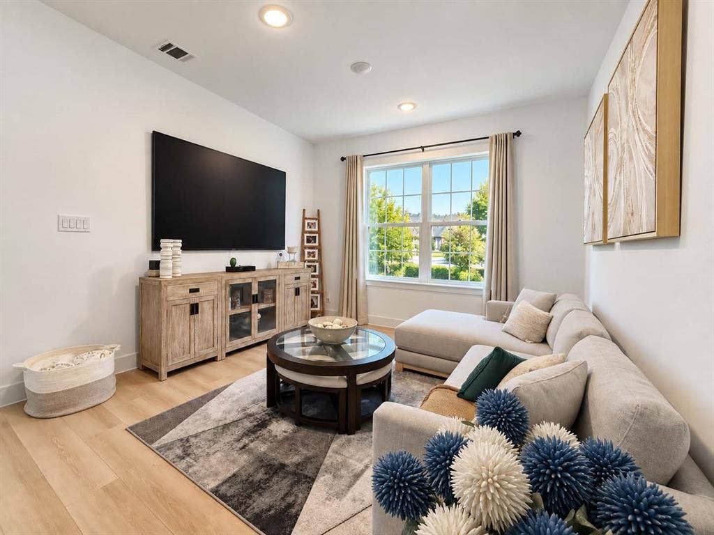 1411 Potenza Road, Fate, TX 75087 Recessed ceiling lighting, wood-finish flooring, a large picture window, and a light-toned sectional