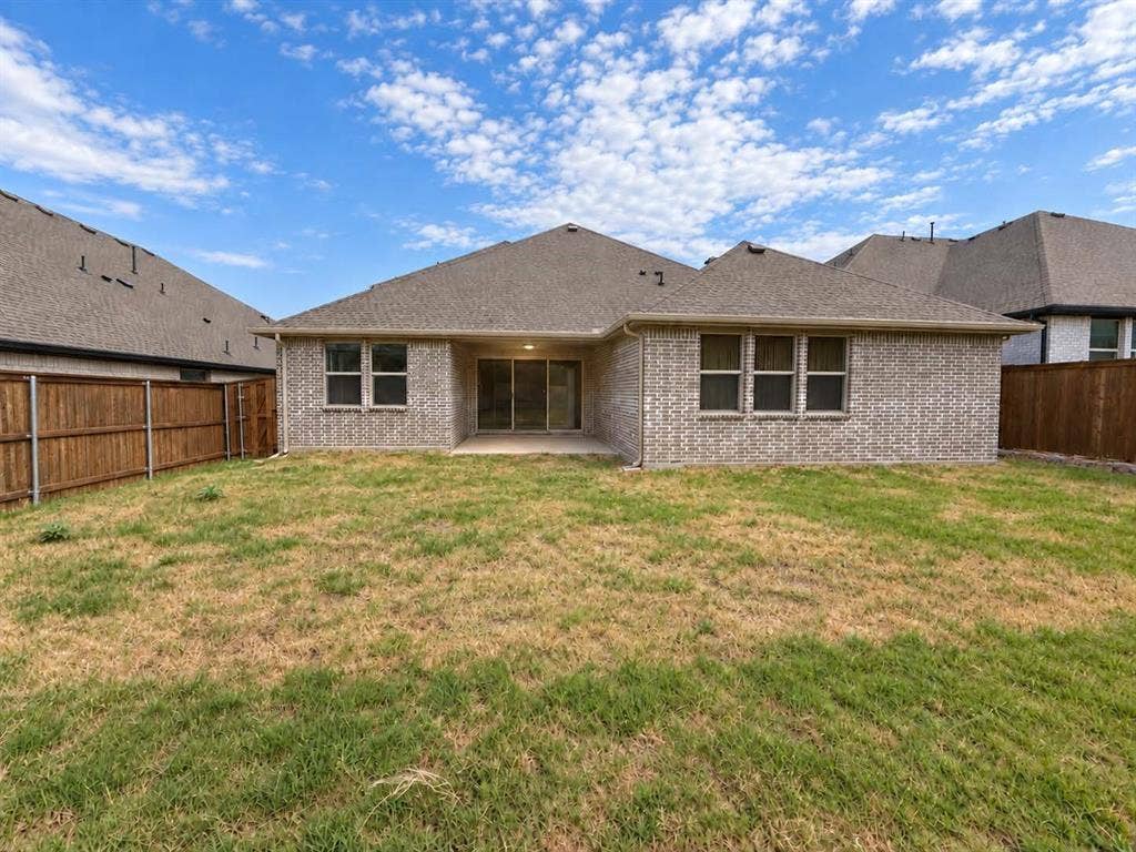 1411 Potenza Road, Fate, TX 75087 Brick exterior with a covered patio and sliding glass doors