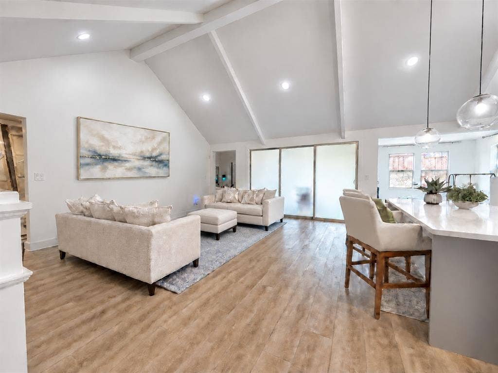 1411 Potenza Road, Fate, TX 75087 Vaulted ceiling with exposed beams, recessed lighting, wood-finish flooring, and a kitchen island with pendant lighting