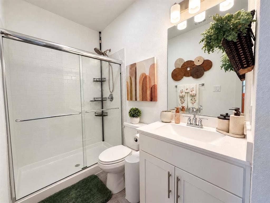 1411 Potenza Road, Fate, TX 75087 White vanity with an integrated sink, polished chrome faucet, and storage cabinetry