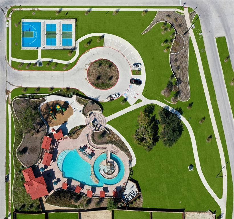 1411 Potenza Road, Fate, TX 75087 Community recreation area featuring a swimming pool, multiple sports courts, a playground, paved walking paths, and expansive landscaped lawns