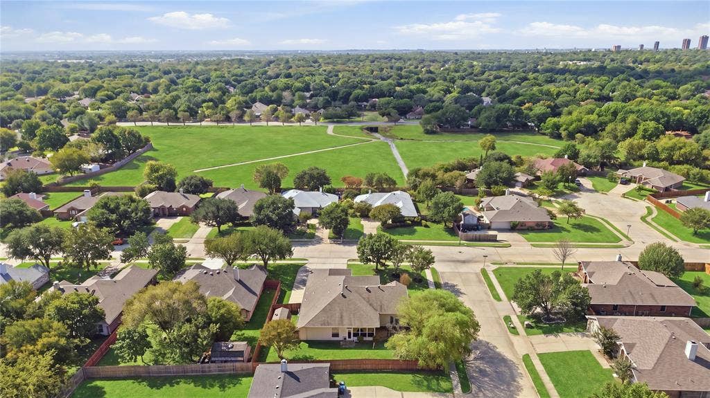 Expansive green space bordered by mature trees