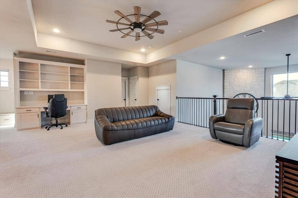 4102 Parkview Boulevard, Celina, TX 75009 Expansive carpeted area featuring a built-in desk and shelving, ceiling fan, recessed lighting, and metal balusters