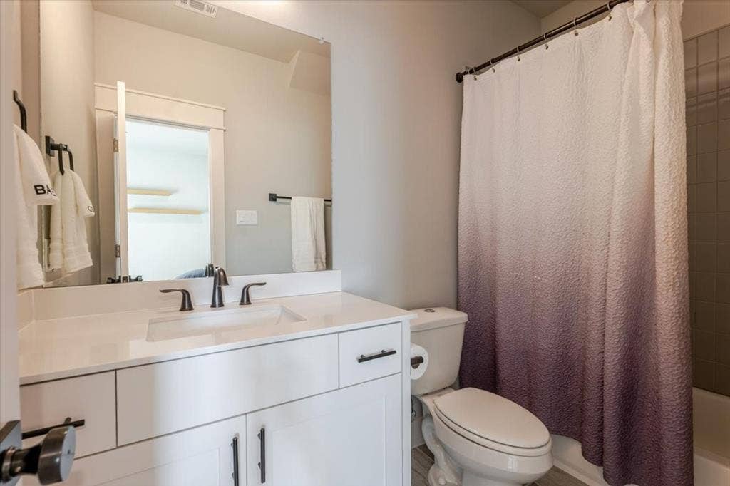 4102 Parkview Boulevard, Celina, TX 75009 White vanity with black hardware, integrated sink, and dark bronze-finish faucet