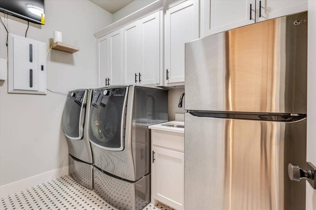 4102 Parkview Boulevard, Celina, TX 75009 White shaker-style cabinetry with black hardware, under-mount sink with matte black faucet, and patterned tile flooring