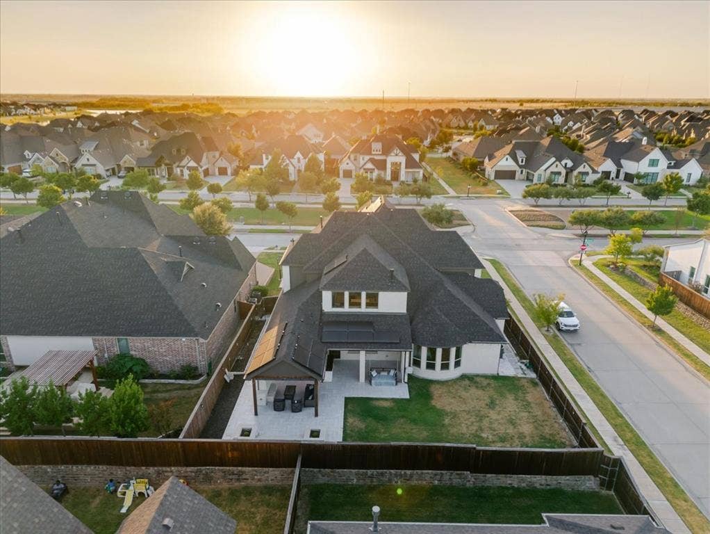 4102 Parkview Boulevard, Celina, TX 75009 Expansive backyard featuring a covered patio, paved outdoor living area, and a privacy fence