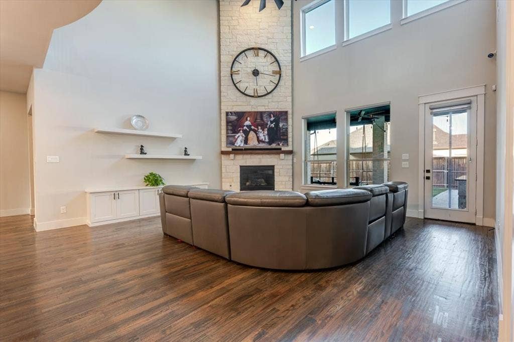 4102 Parkview Boulevard, Celina, TX 75009 Vaulted ceiling with a stone-clad fireplace and wood-finish flooring