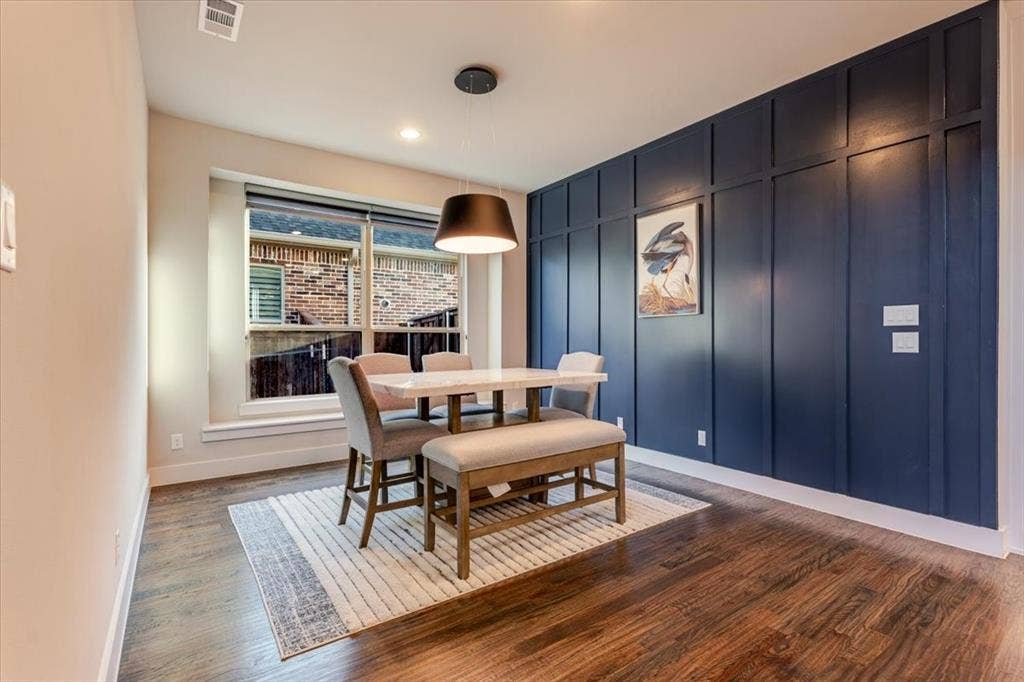 4102 Parkview Boulevard, Celina, TX 75009 Dark wood-finish flooring, accent wall with decorative paneling, recessed lighting, and a modern pendant light fixture