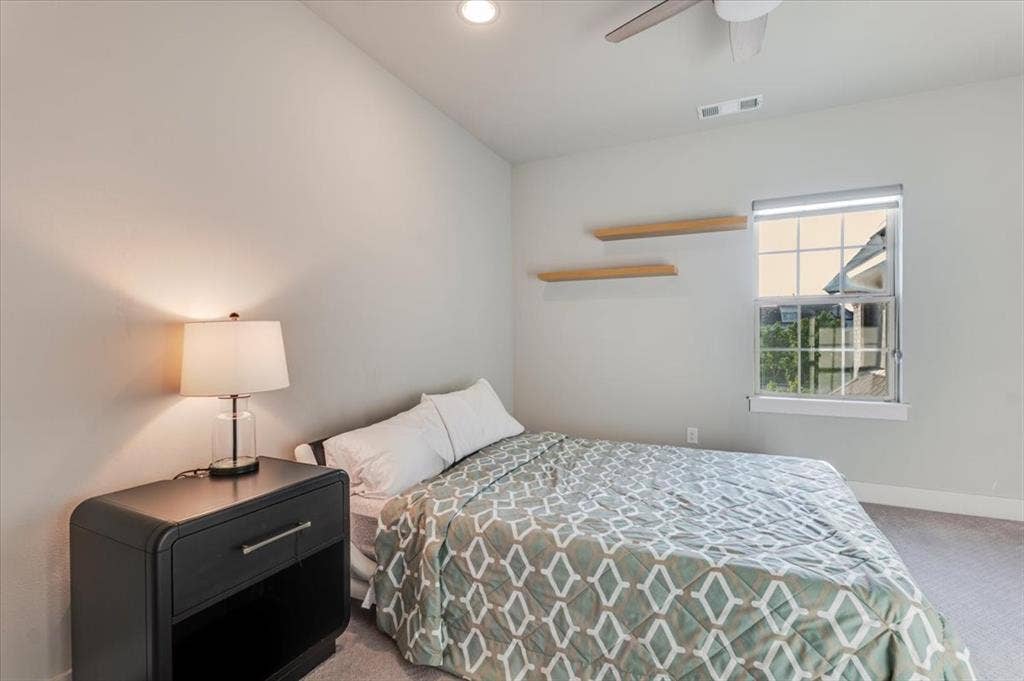 4102 Parkview Boulevard, Celina, TX 75009 Recessed lighting, ceiling fan, window with roller shade, and two wall-mounted floating shelves