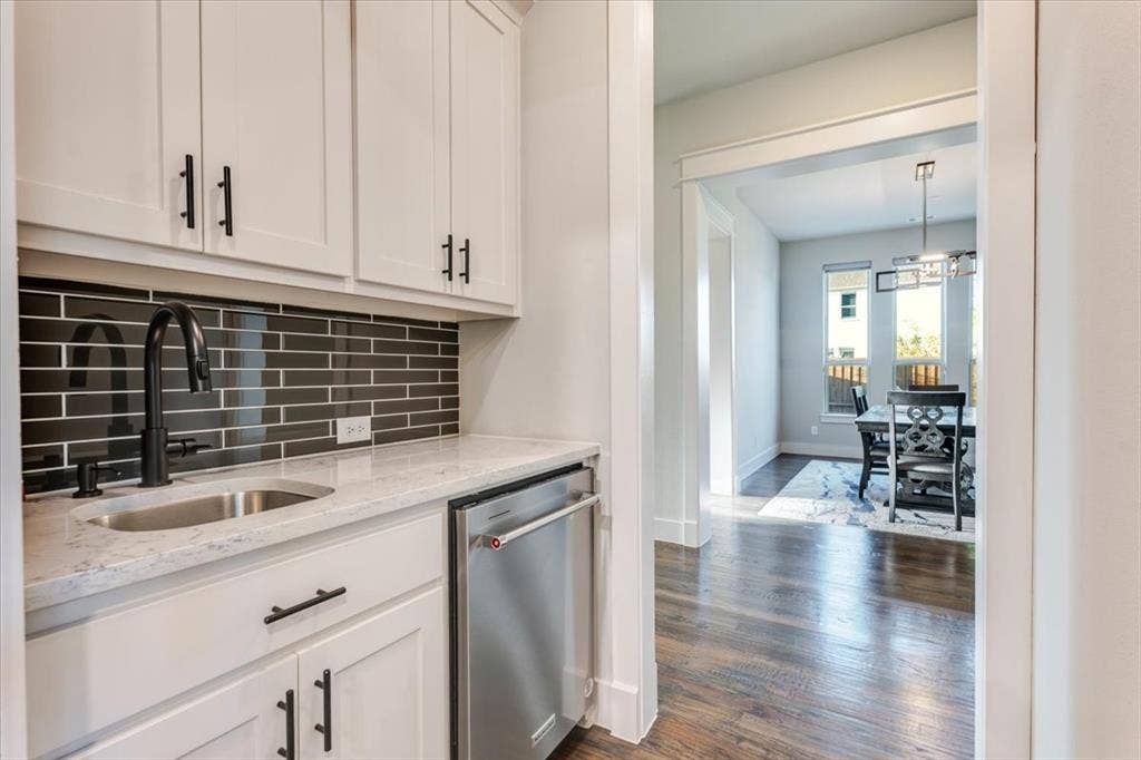 4102 Parkview Boulevard, Celina, TX 75009 Custom beverage station with white cabinetry, a stainless steel sink, black subway tile backsplash, and a built-in stainless steel appliance