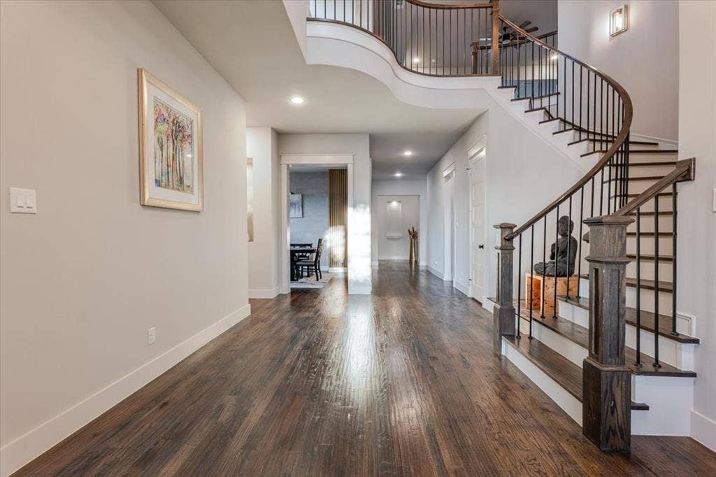 4102 Parkview Boulevard, Celina, TX 75009 Hardwood flooring, curved staircase with wrought iron balusters, recessed lighting, and a neutral wall color