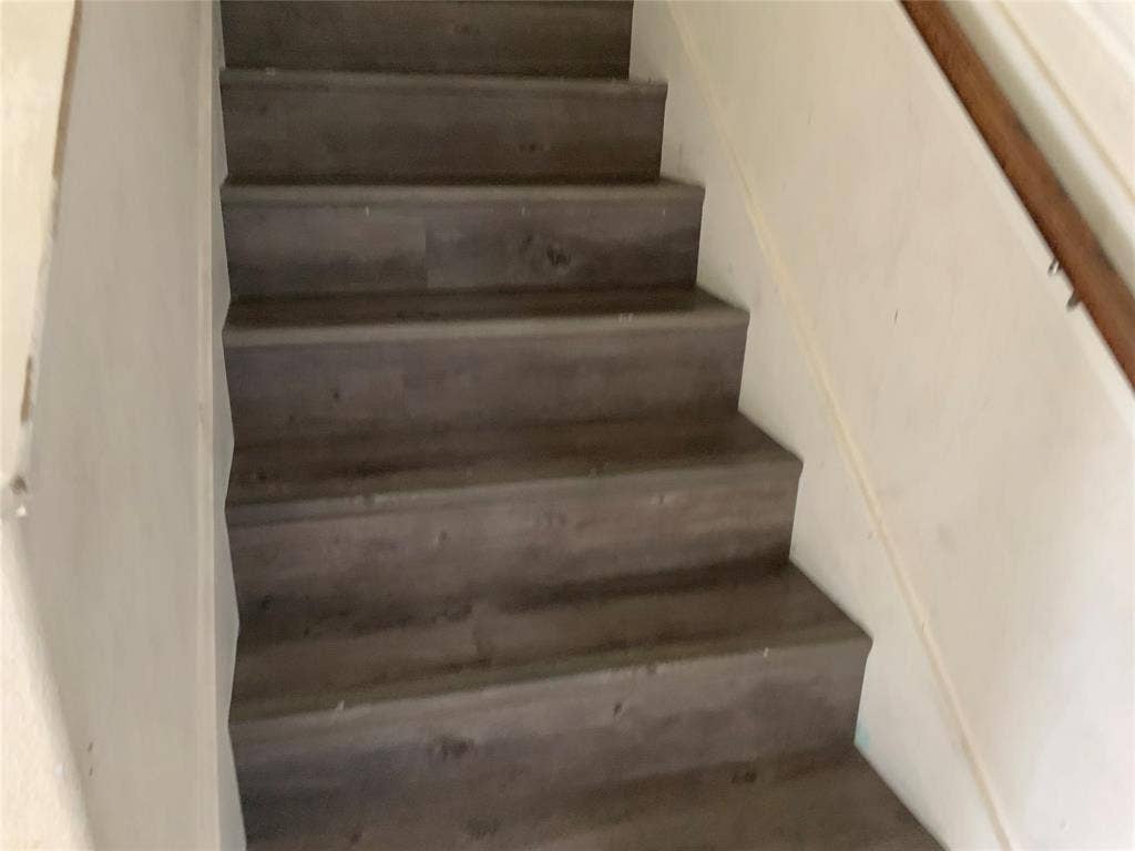 1030 Stanwyck Avenue, Duncanville, TX 75137 Staircase featuring wood-finish treads and risers, and a wood handrail