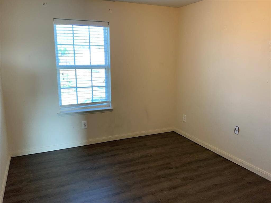 1030 Stanwyck Avenue, Duncanville, TX 75137 Wood-finish flooring with a window featuring horizontal blinds