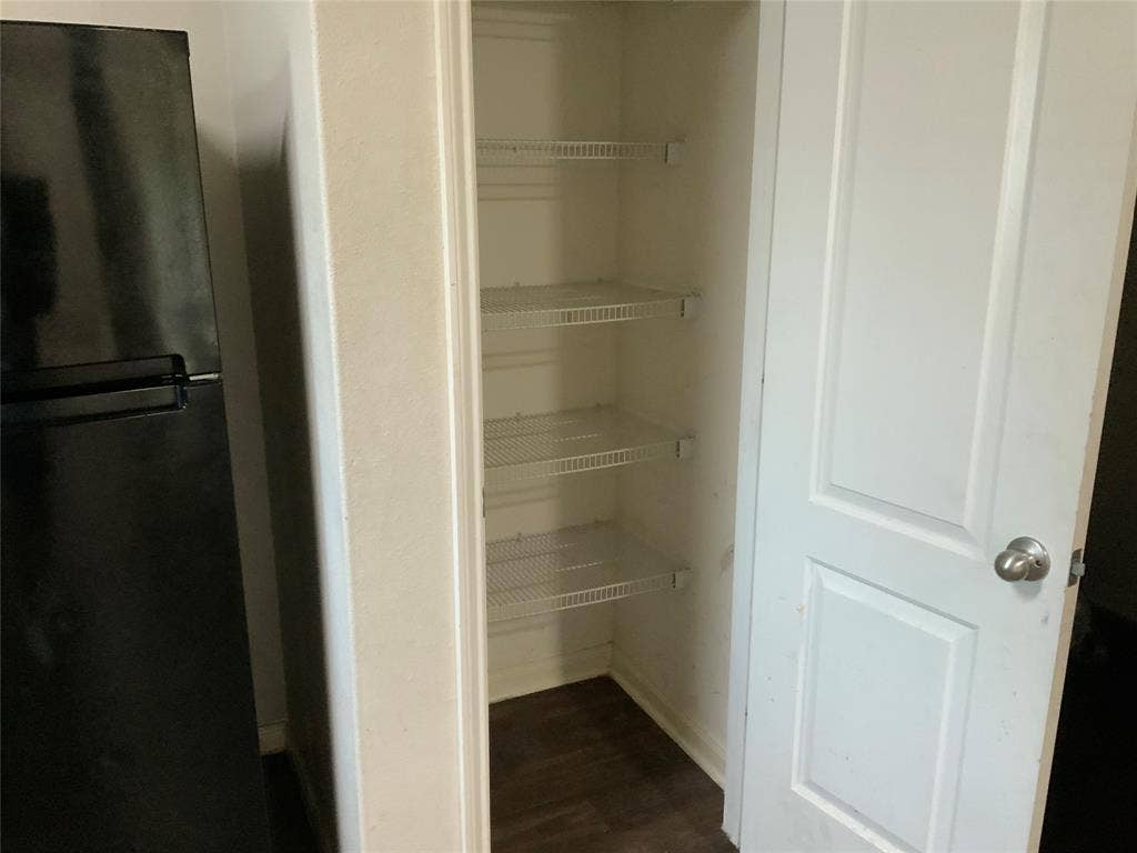 1030 Stanwyck Avenue, Duncanville, TX 75137 Built-in pantry with wire shelving and wood-finish flooring