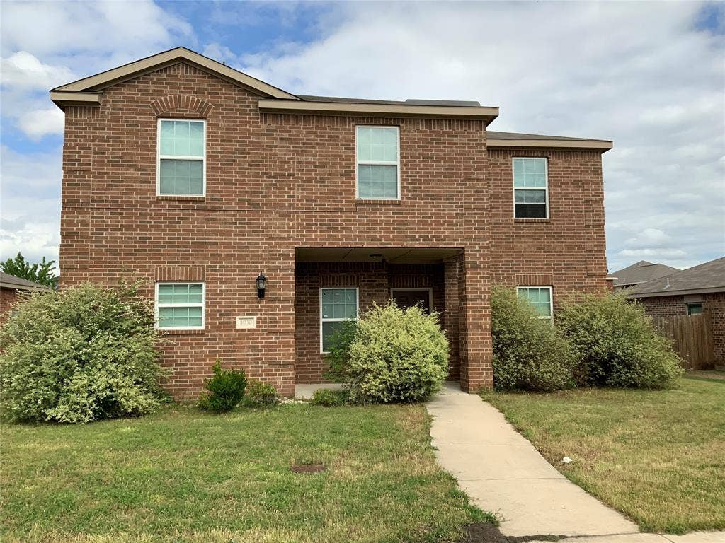 1030 Stanwyck Avenue, Duncanville, TX 75137 Brick exterior construction with multiple windows, covered entry, and a concrete pathway