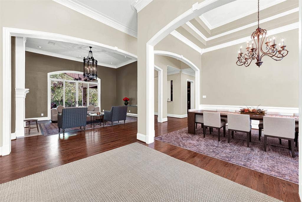 5237 SKY LAKE Drive, Plano, TX 75093 Grand arched openings create sightlines across connecting living zones while daylight bounces over polished hardwood flooring. Picture guests flowing effortlessly between conversations during a lively evening gathering