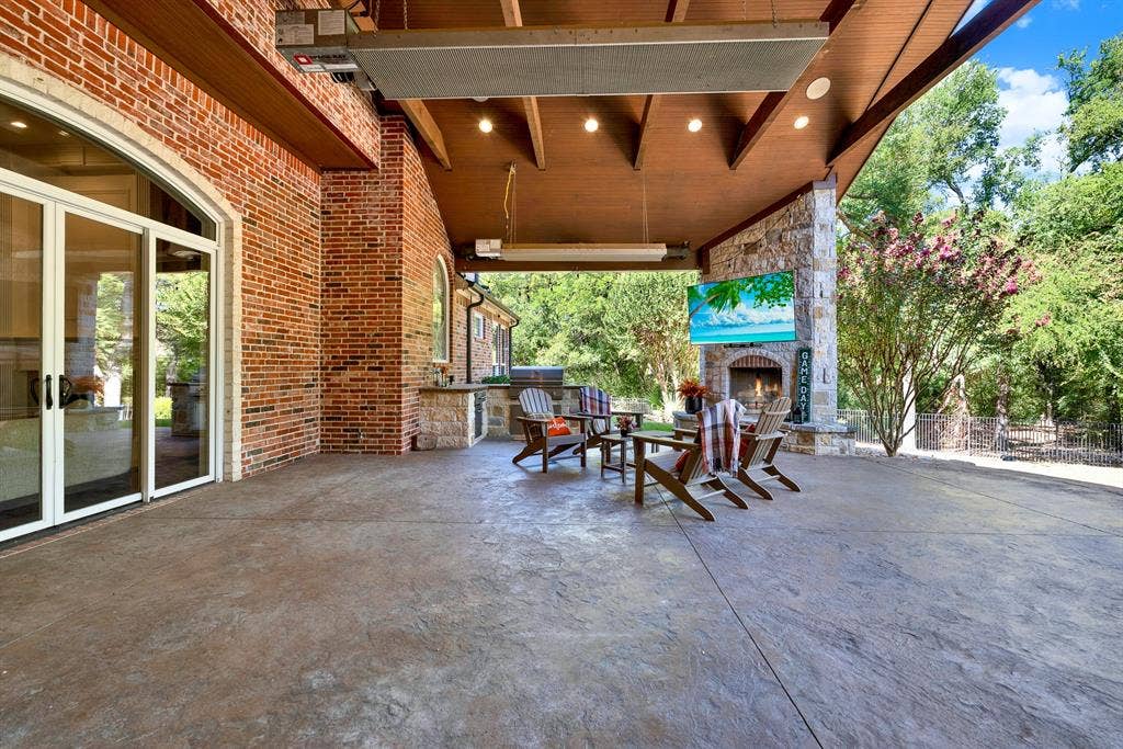5237 SKY LAKE Drive, Plano, TX 75093 Wide glass sliding doors dissolve the boundary between rich interior brickwork and the vast covered stone patio. Host weekend game-day watch parties where guests seamlessly drift between indoor comforts and fresh open air.