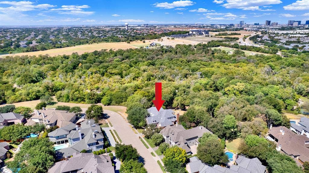 5237 SKY LAKE Drive, Plano, TX 75093 The expansive neighborhood view highlights how the estate bridges vibrant suburban life with dense forest acreage. Picture hosting neighborhood block parties before retreating to your private, tree-lined sanctuary