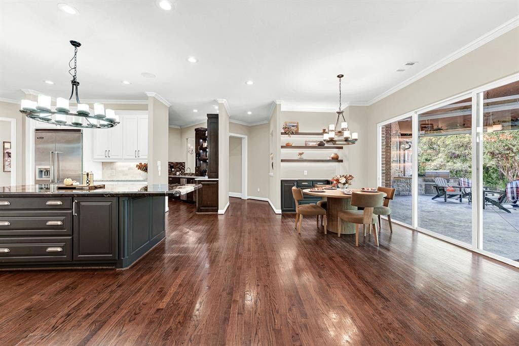 5237 SKY LAKE Drive, Plano, TX 75093 Wide glass sliding doors dissolve the boundary between rich interior brickwork and the vast covered stone patio. Host weekend game-day watch parties where guests seamlessly drift between indoor comforts and fresh open air.