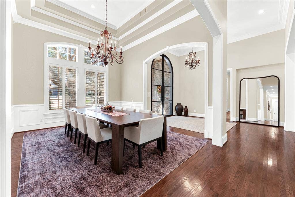 5237 SKY LAKE Drive, Plano, TX 75093 Tall transomed windows let gentle daylight dance across the classic white wall paneling. Visualize lingering over dessert with loved ones as dusk settles outside.