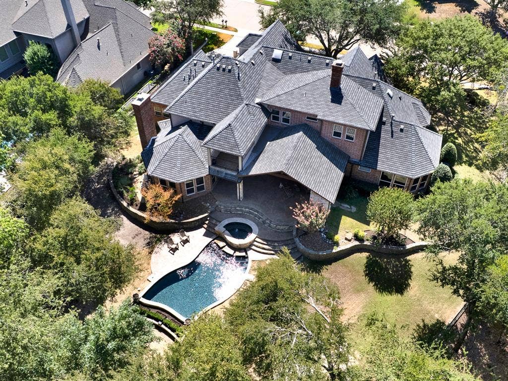 5237 SKY LAKE Drive, Plano, TX 75093 Welcome to 5237 Sky Lake. Prominent brick chimneys accent multi-angled rooflines that frame an inviting poolside patio space. Enjoy quiet evening cocktails while watching afternoon sun shadows stretch across stone terraces
