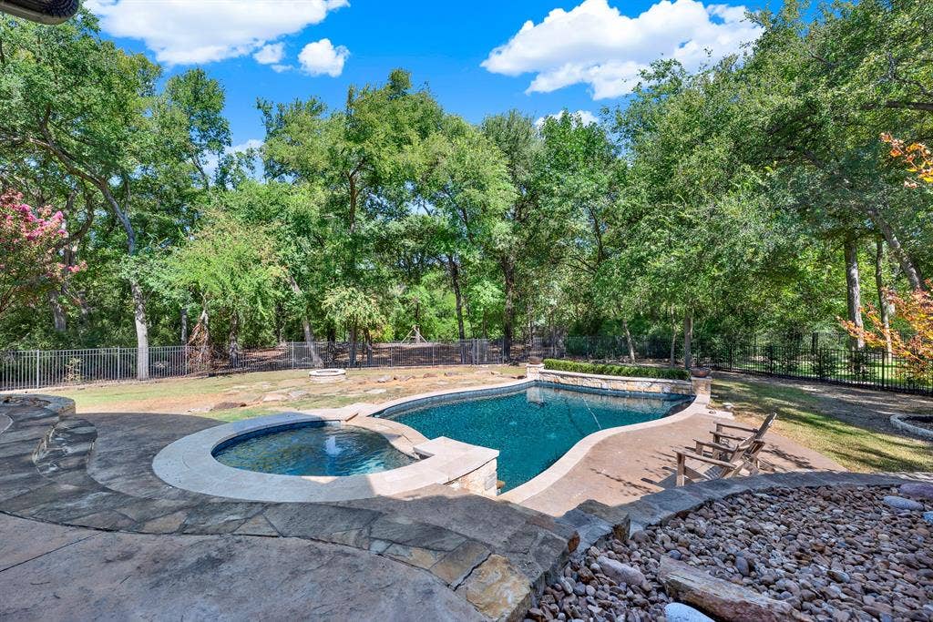 5237 SKY LAKE Drive, Plano, TX 75093 Curving stone coping defines a sparkling pool and spa set against a lush, forest-like tree line. Spend sunny summer afternoons floating lazily while listening to breeze rustling through the canopy.
