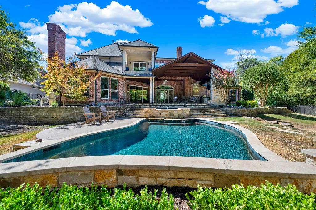 5237 SKY LAKE Drive, Plano, TX 75093 A covered outdoor living structure overlooks the brilliant turquoise pool waters. Host unforgettable weekend barbecues where friends relax poolside late into the warm evening.