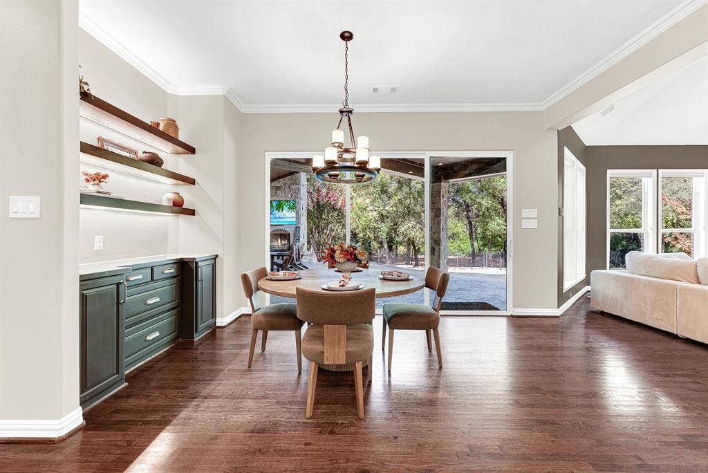 5237 SKY LAKE Drive, Plano, TX 75093 A built-in sideboard niche with warm floating shelves anchors the space against a wall of sliding glass doors. Morning sunlight streams across the rich wood floors as you brew your favorite roast.