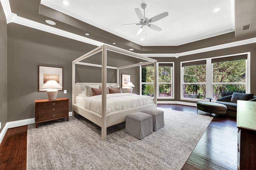 5237 SKY LAKE Drive, Plano, TX 75093 Deep tray ceiling molding and wide picture windows surround the suite with peaceful garden views. Wake up slowly to soft morning light filtering through private, tree-lined glass panes.