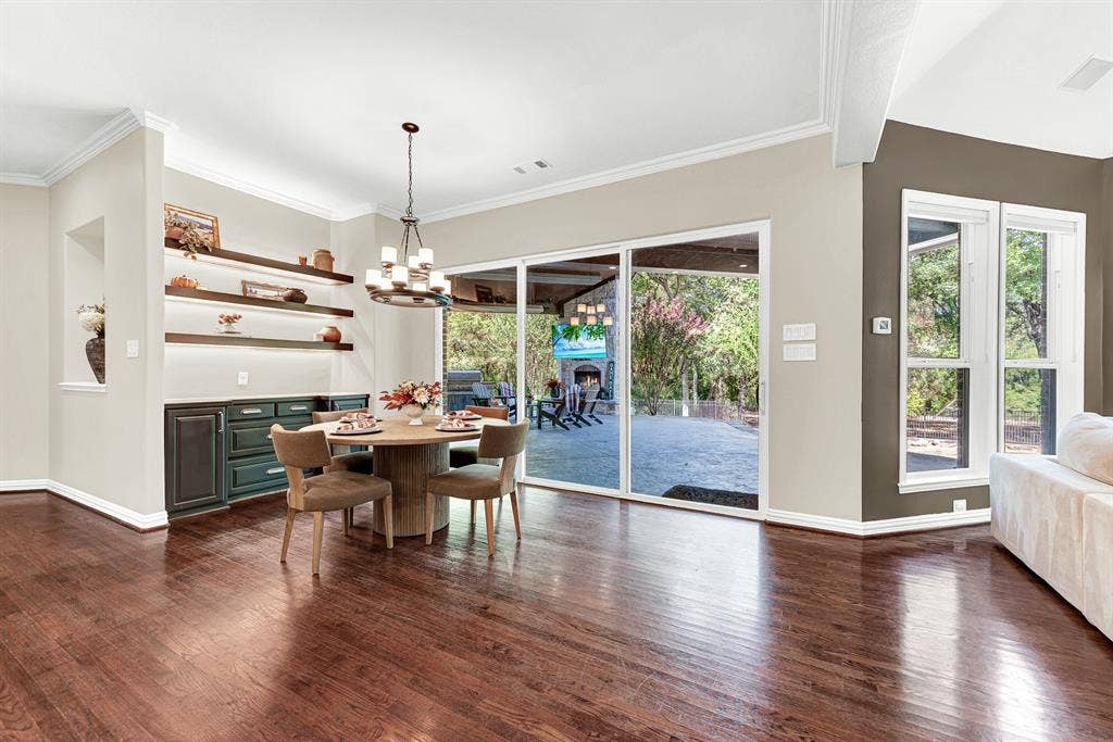 5237 SKY LAKE Drive, Plano, TX 75093 Expansive glass sliders create a fluid transition directly to the covered patio, flooding the room with natural light. You can easily share casual weekday breakfasts while taking in views of the lush backyard greenery.