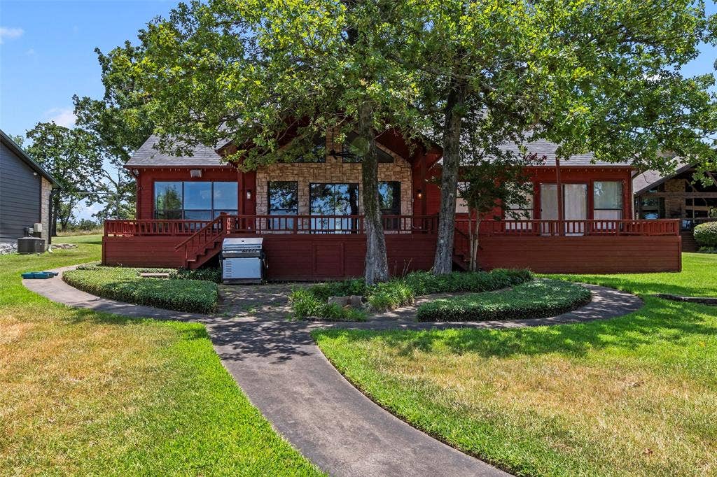 5459 Woodland Shores Drive, Log Cabin, TX 75148 Waterside view of the home.