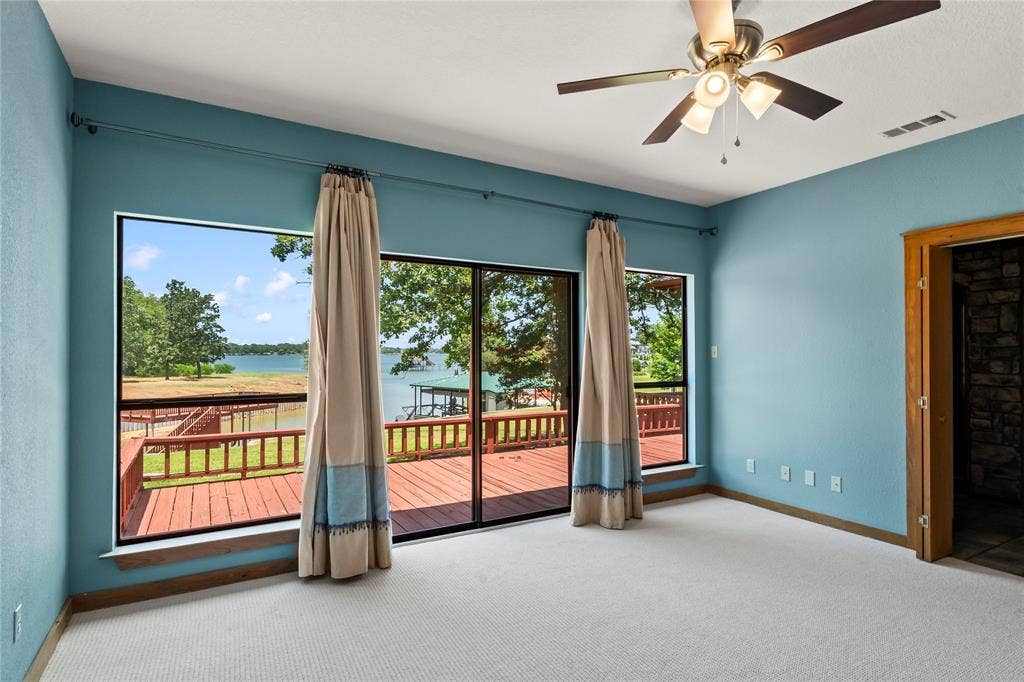 5459 Woodland Shores Drive, Log Cabin, TX 75148 Waterside Primary Suite with doors to the back deck and lovely views.