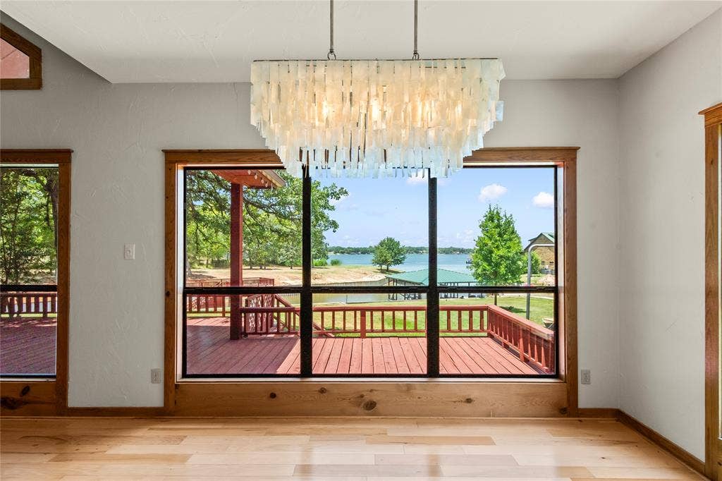 5459 Woodland Shores Drive, Log Cabin, TX 75148 Lovely dining area with large windows showcasing open water views.