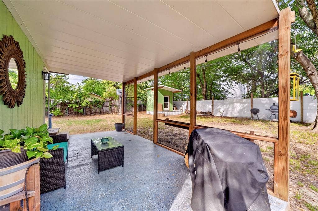302 Longleaf Street, Gun Barrel City, TX 75156 Covered patio featuring a solid roof, wood-beam supports, and a painted concrete floor