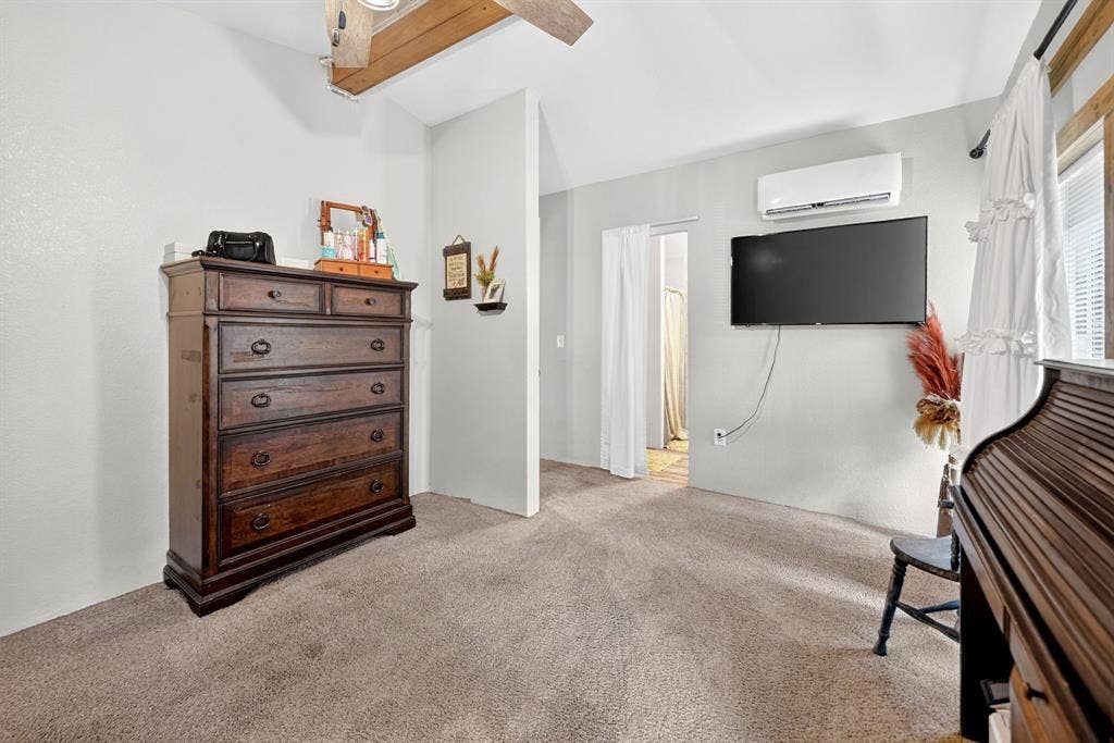 302 Longleaf Street, Gun Barrel City, TX 75156 Carpeted flooring, vaulted ceiling with exposed wood beams, and a wall-mounted mini-split system