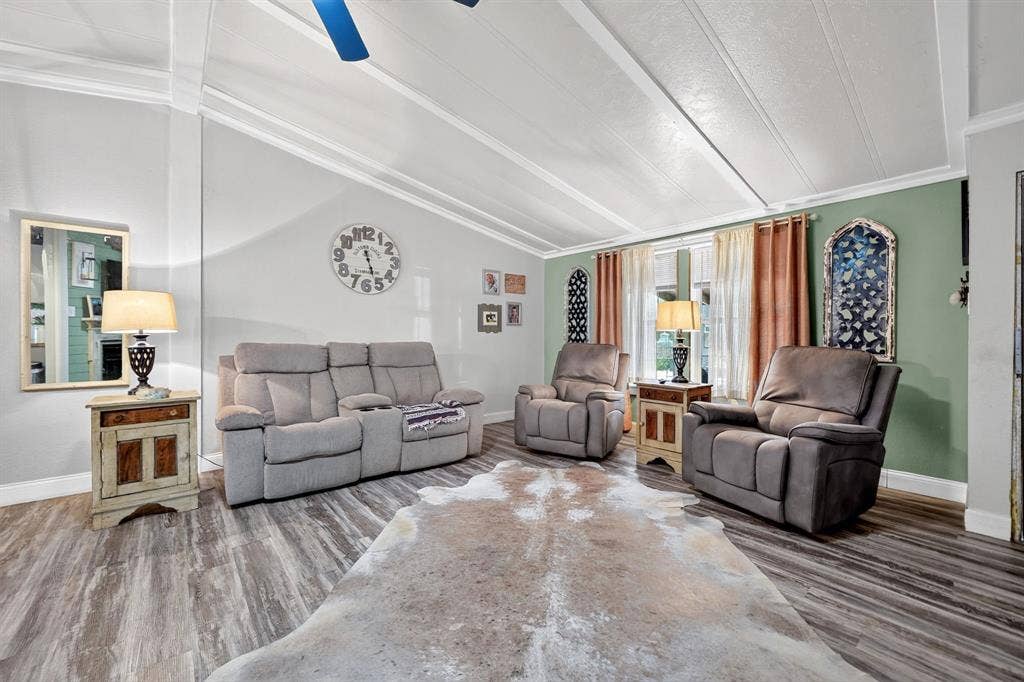 302 Longleaf Street, Gun Barrel City, TX 75156 Vaulted ceiling with exposed beams, wood-finish flooring, recessed windows, and a ceiling fan
