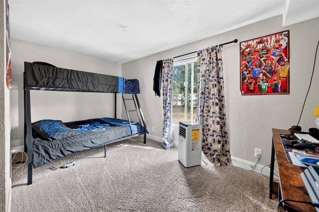 302 Longleaf Street, Gun Barrel City, TX 75156 Window with natural light, wall-to-wall carpeting, painted walls, and ceiling