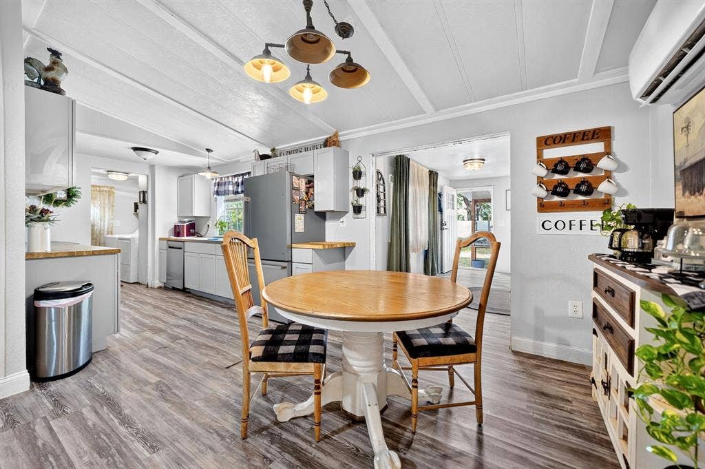 302 Longleaf Street, Gun Barrel City, TX 75156 Wood-finish flooring throughout, light gray cabinetry, stainless steel appliances, and a coffered ceiling