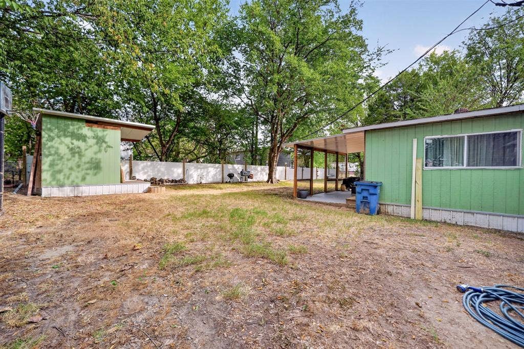 302 Longleaf Street, Gun Barrel City, TX 75156 Expansive outdoor space featuring a covered patio, a detached covered structure, and a perimeter fence
