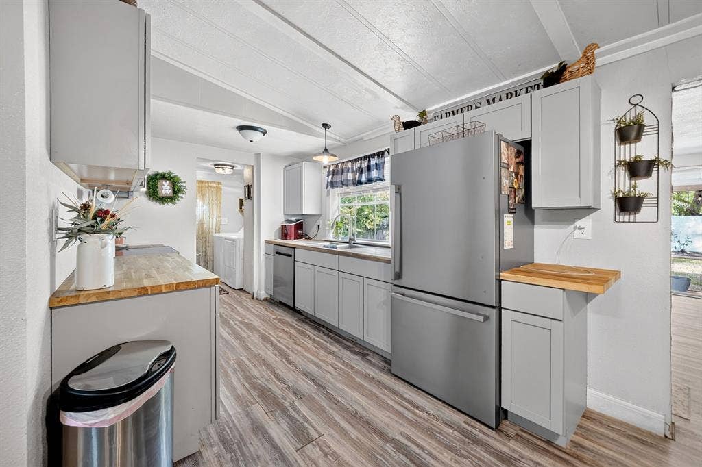 302 Longleaf Street, Gun Barrel City, TX 75156 Kitchen featuring light gray cabinetry, wood-finish countertops, stainless steel appliances, and wood-finish flooring