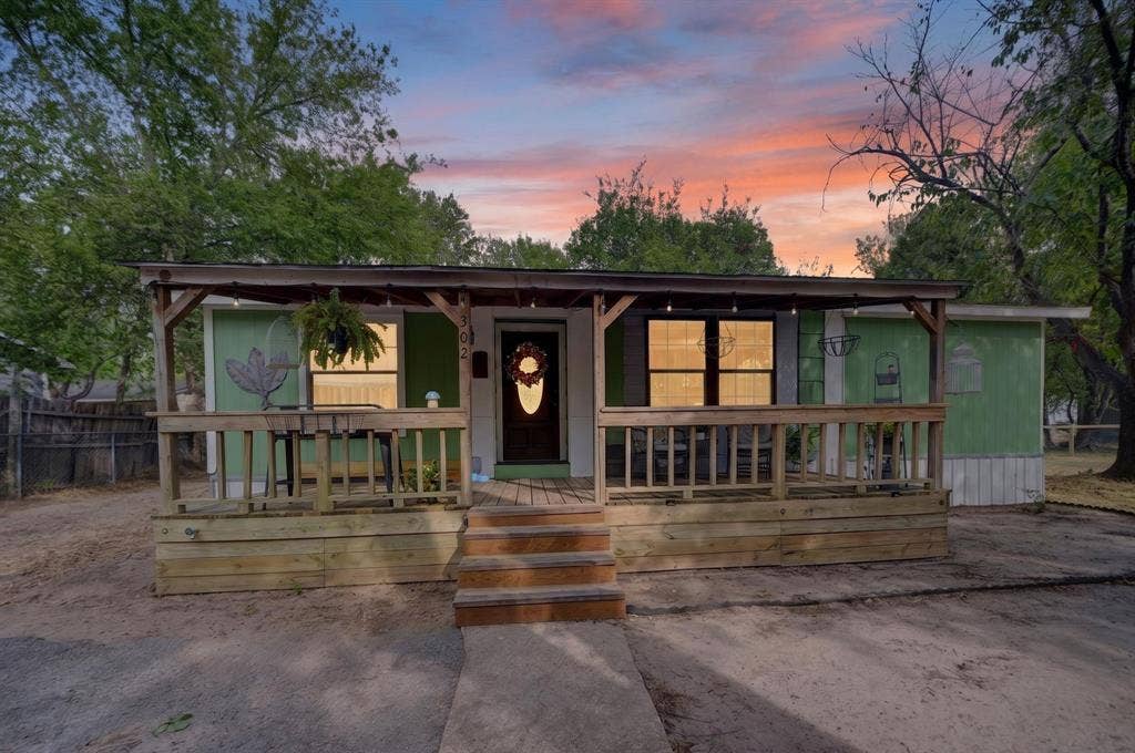 302 Longleaf Street, Gun Barrel City, TX 75156 Covered porch with wood railing and steps