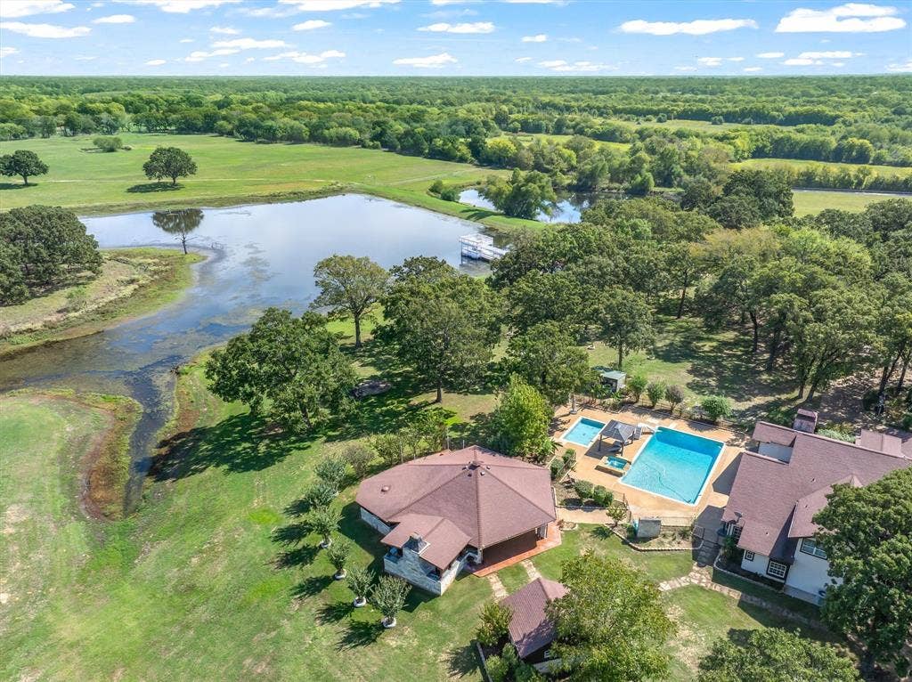 323 County Road 3507, Edgewood, TX 75117 Incredible 79 acre ranch in Edgewood Tx, 50 miles from Dallas. Beautiful rolling terrain, huge pool and entertainment area, 6164 SF home over looking magnificent lake, 8400 SF party barn, and equipment barn, hay barn, plenty of room for recreation, horses and cattle. Do not miss this one.
