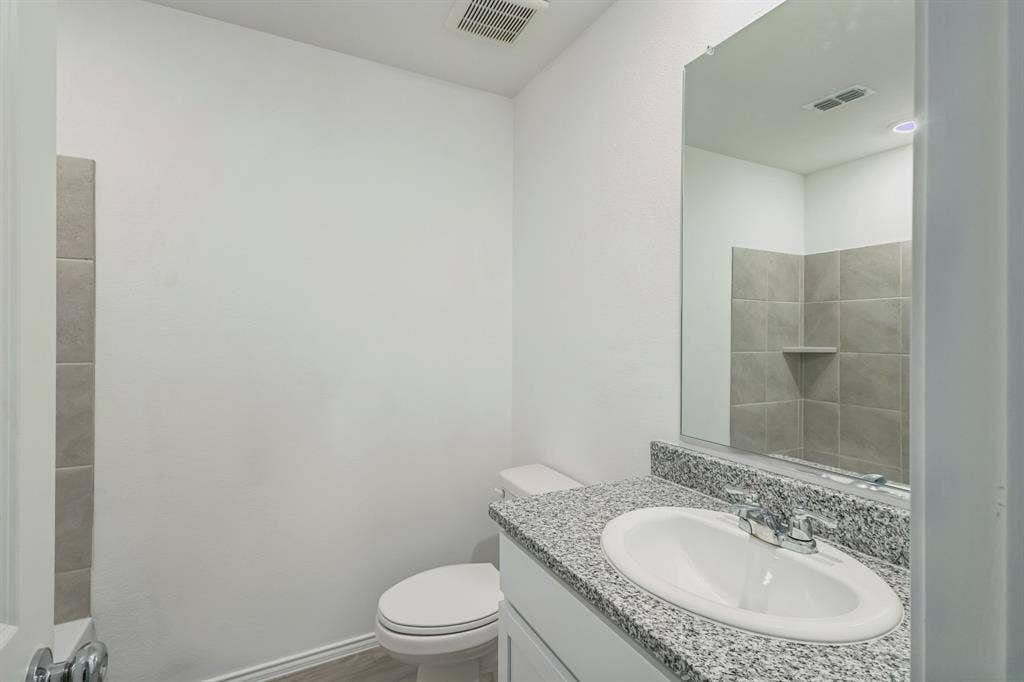 7904 Thornton Drive, McKinney, TX 75071 Vanity with speckled countertop, undermount sink, and chrome faucet