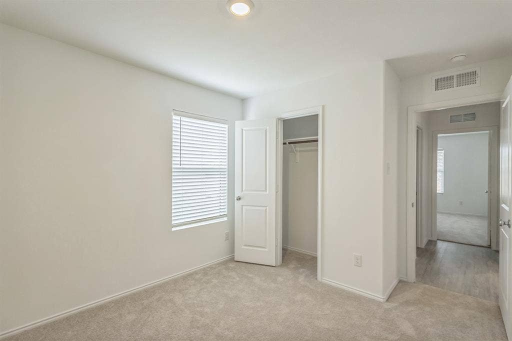 7904 Thornton Drive, McKinney, TX 75071 Carpeted room with a window, white blinds, and a built-in closet