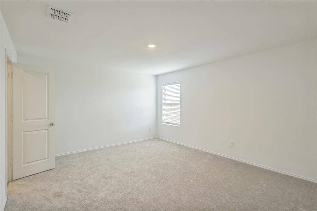 7904 Thornton Drive, McKinney, TX 75071 Spacious room featuring light-colored carpeting, a single window with blinds, and a white interior door