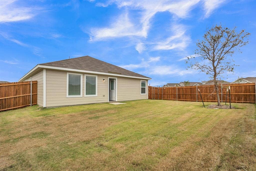 7904 Thornton Drive, McKinney, TX 75071 Expansive backyard featuring a new privacy fence, mature trees, a well-maintained lawn, and a neutral-toned exterior