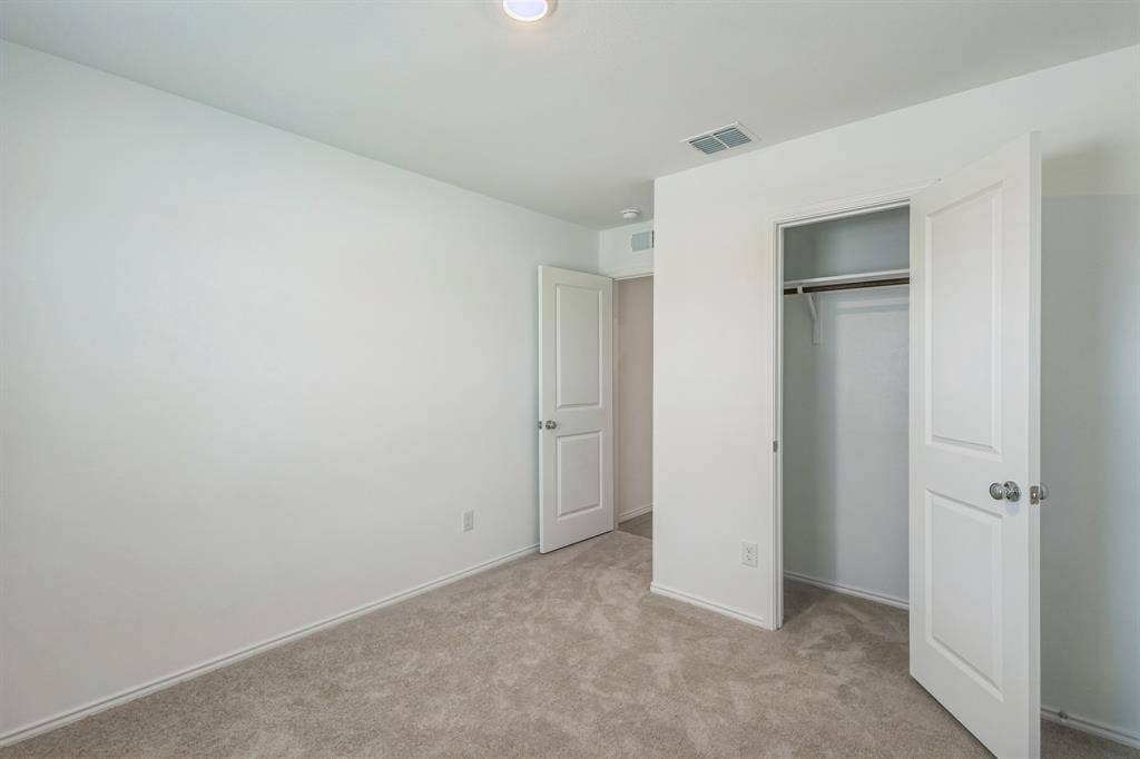 7904 Thornton Drive, McKinney, TX 75071 Recessed ceiling lighting, neutral carpeting, and a built-in closet with shelving and hanging rod